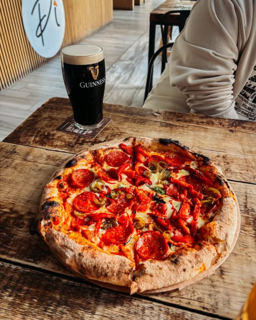 A spicy pepperoni pizza with a pint of Guinness from Pi Pizza Derry at Clipper Quay Street Food Market.